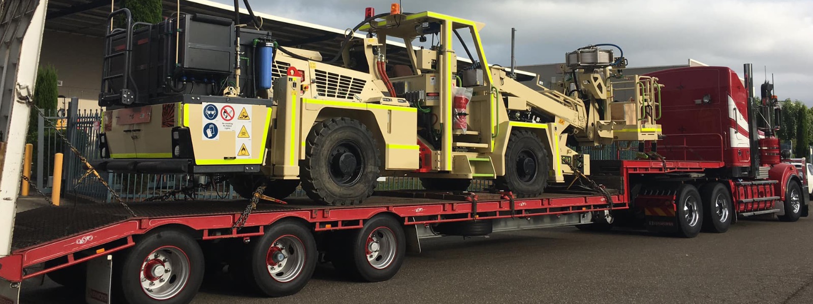 Conquest Semi truck with a small dozer loaded on the trailer