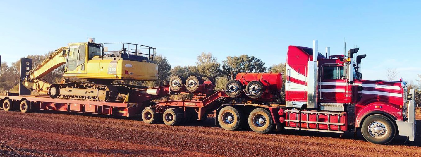 Conquest Semi truck with a small dozer loaded on the trailer